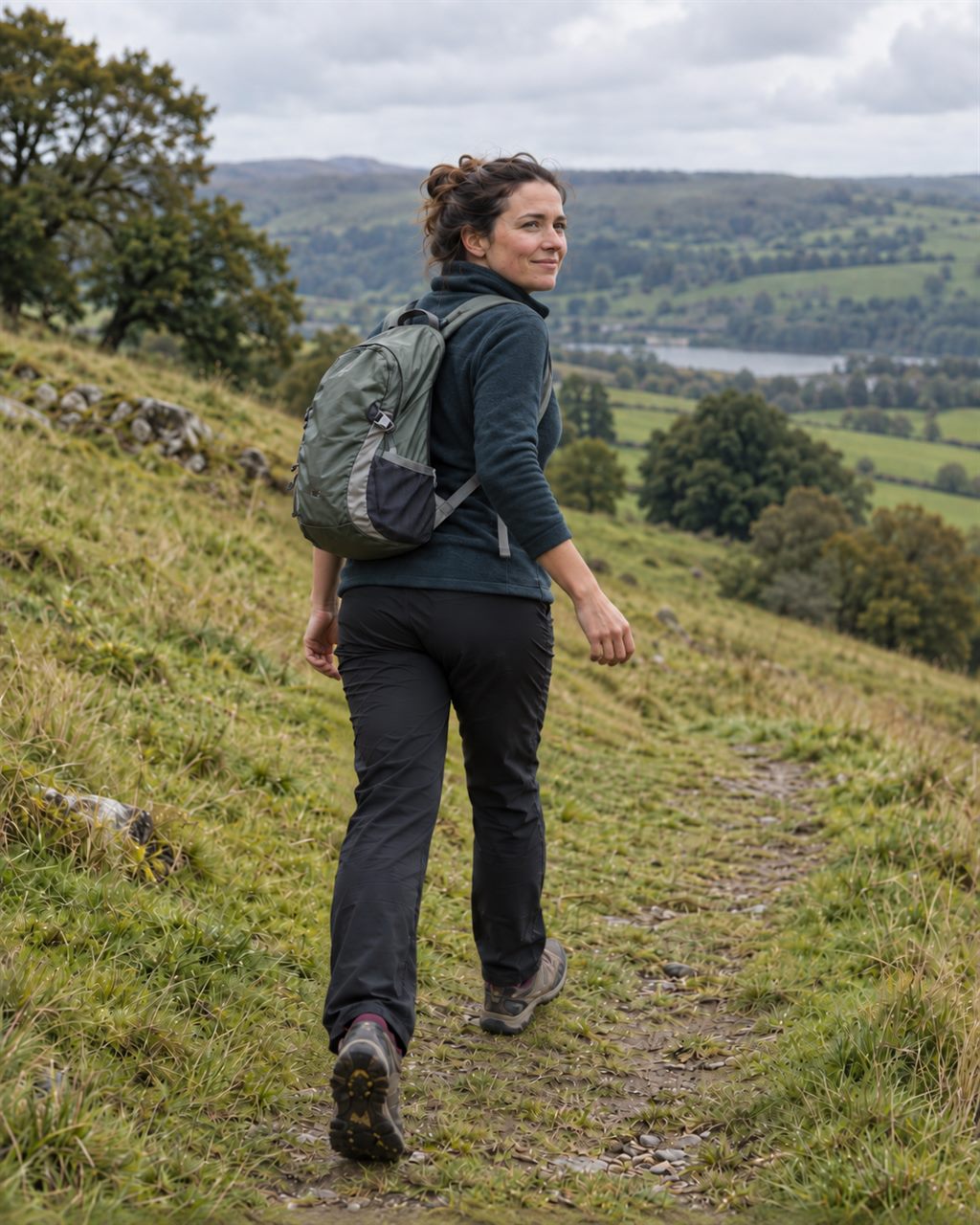 The same woman on the same hill path twelve weeks later, smiling and relaxed